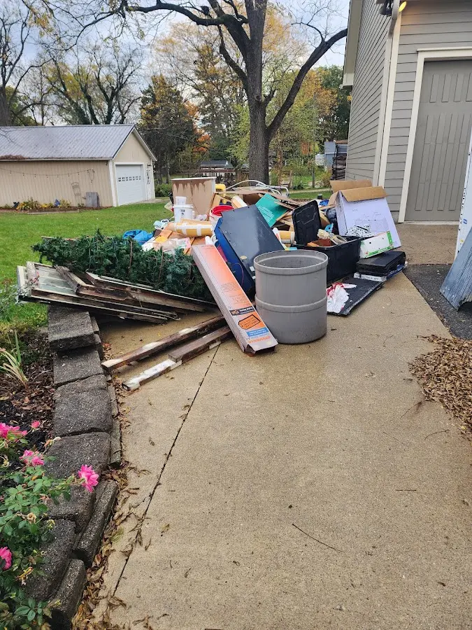 Dumpster being loaded with debris for Estate Cleanout Dumpster Rental in Fort Ann